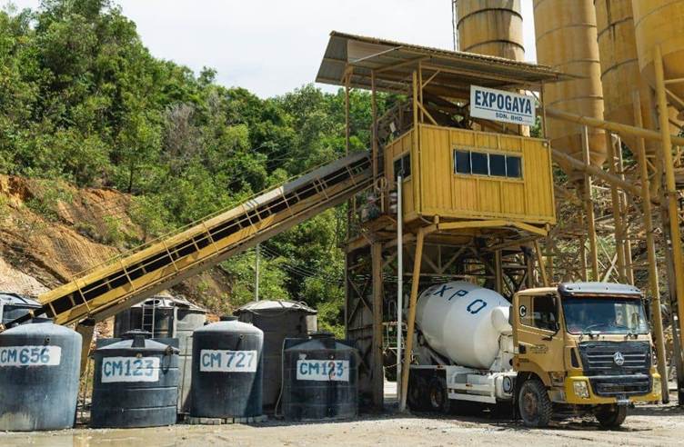 A truck loading cement into a factory

AI-generated content may be incorrect.